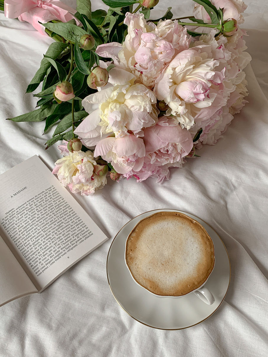 Pink Flowers near a Book and a Cup of Coffee